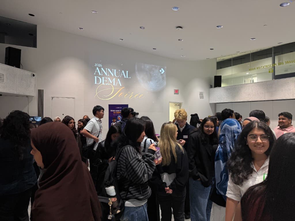 Students and guests networking at The Blind Duck under the 2026 Annual DEMA Soirée projection