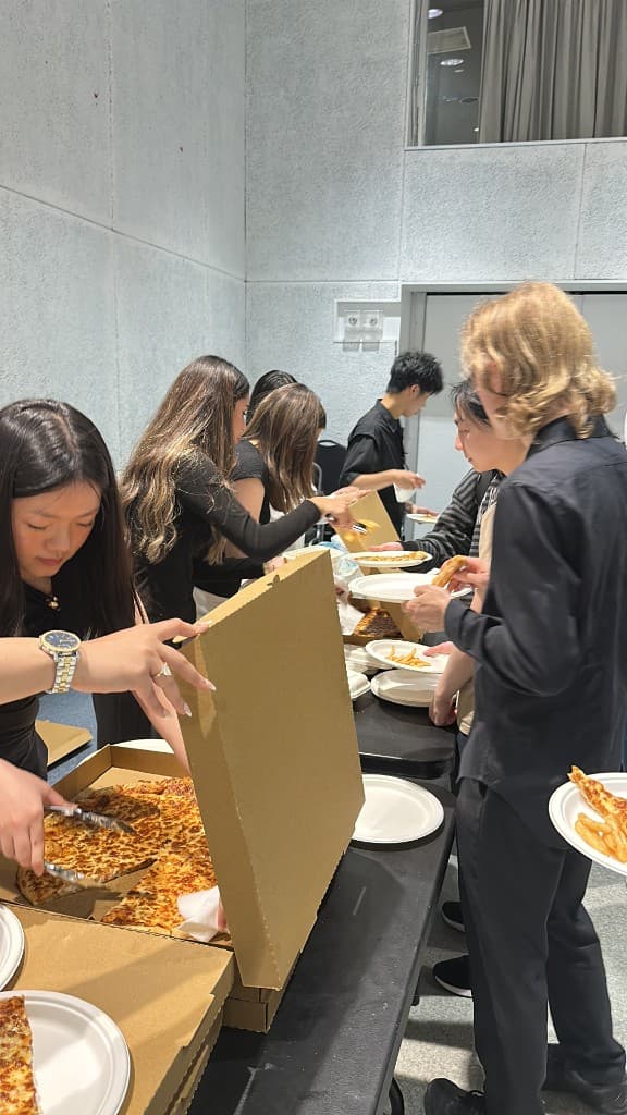 Guests lining up for pizza at the Soirée